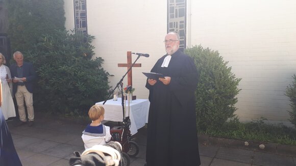 Der Pastor am portablen Altar vor der Kirche